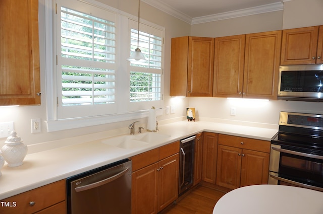 4810 Glenmist Ct, Raleigh, NC 27612 - kitchen featuring appliances with stainless steel finishes, ornamental molding, a sink, and brown cabinetry