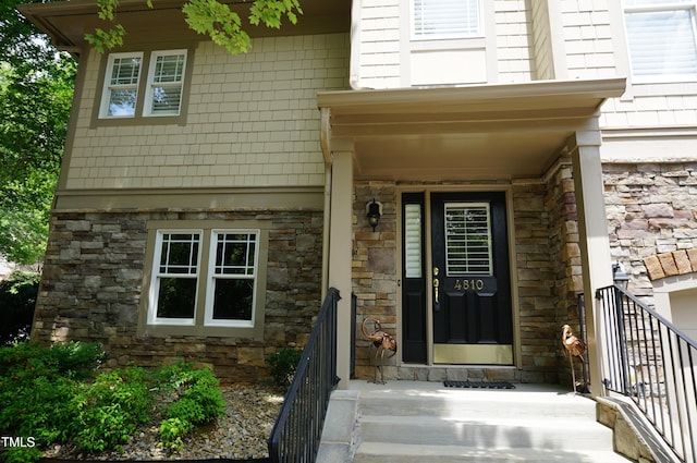 4810 Glenmist Ct, Raleigh, NC 27612 - view of exterior entry featuring stone siding and a porch