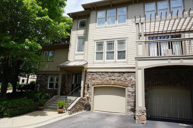 4810 Glenmist Ct, Raleigh, NC 27612 - view of front of property featuring stone siding, an attached garage, a balcony, and driveway