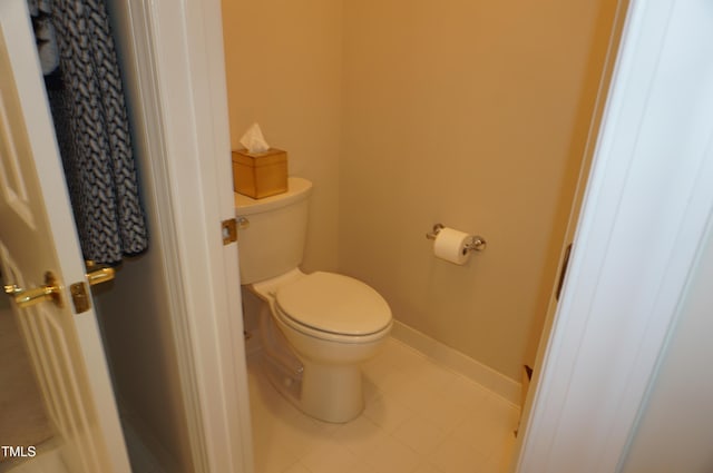 4810 Glenmist Ct, Raleigh, NC 27612 - bathroom featuring toilet, baseboards, and tile patterned floors
