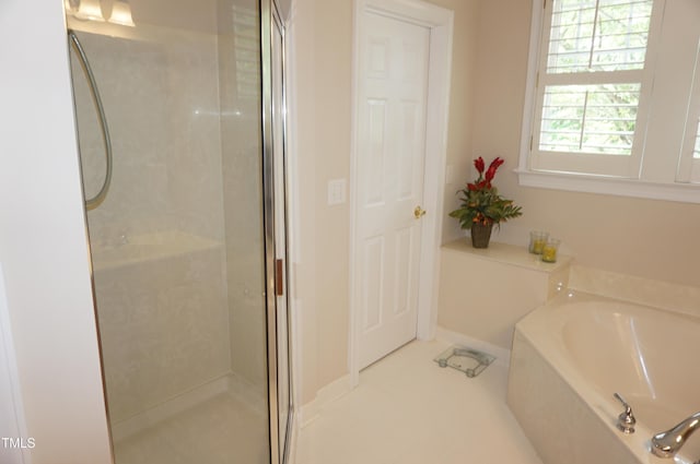 4810 Glenmist Ct, Raleigh, NC 27612 - bathroom with a shower stall, a garden tub, and tile patterned floors