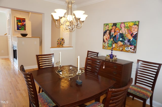 4810 Glenmist Ct, Raleigh, NC 27612 - dining area with a chandelier, ornamental molding, light wood-type flooring, and baseboards
