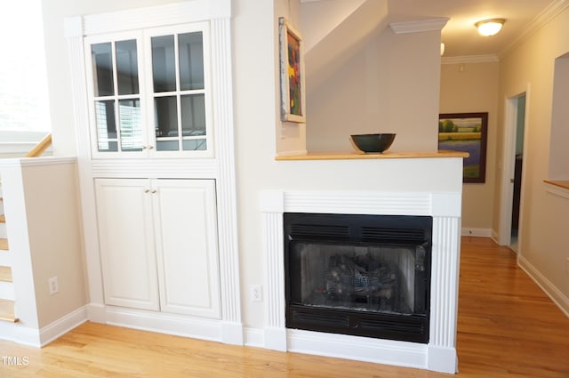 4810 Glenmist Ct, Raleigh, NC 27612 - detailed view of wood finished floors, baseboards, crown molding, and a fireplace