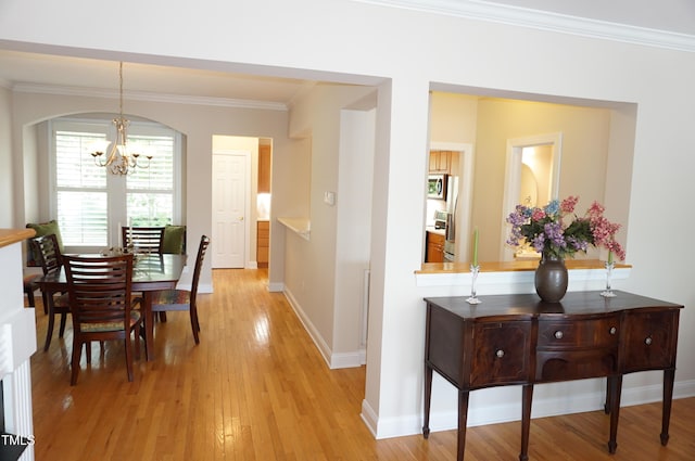 4810 Glenmist Ct, Raleigh, NC 27612 - hall with a chandelier, ornamental molding, light wood-style flooring, and baseboards