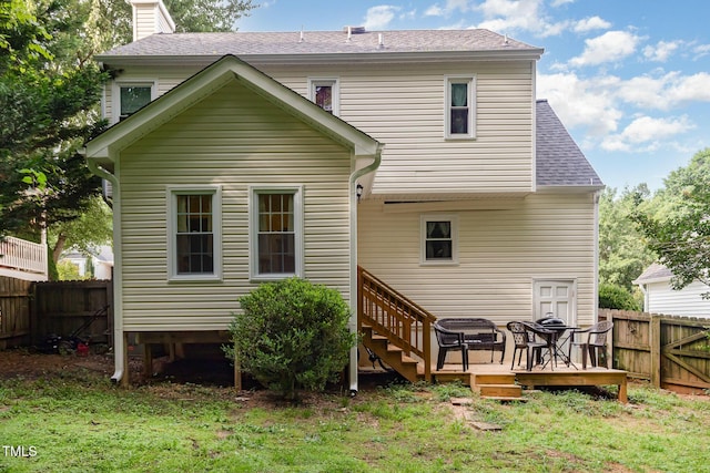 713 Saint Catherines Dr, Wake Forest, NC 27587 - back of house featuring a fenced backyard, a wooden deck, a chimney, and a shingled roof