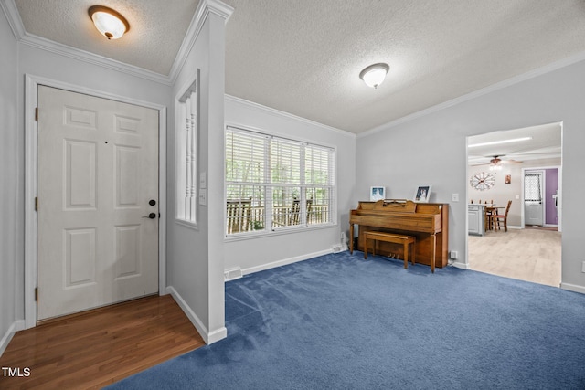 117 Lema Dr, Garner, NC 27529 - entryway with carpet, a textured ceiling, ceiling fan, ornamental molding, and baseboards