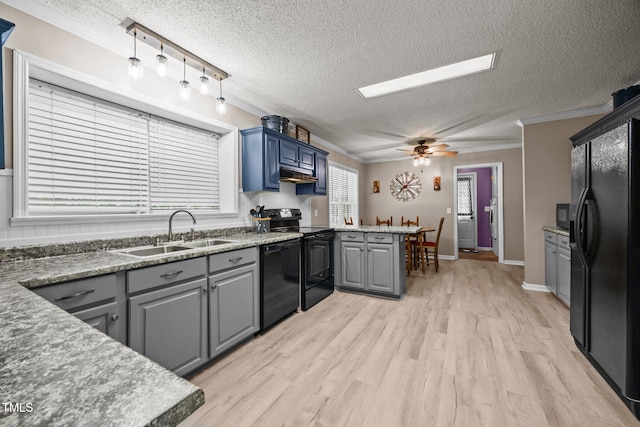117 Lema Dr, Garner, NC 27529 - kitchen with a sink, black appliances, under cabinet range hood, crown molding, and a textured ceiling