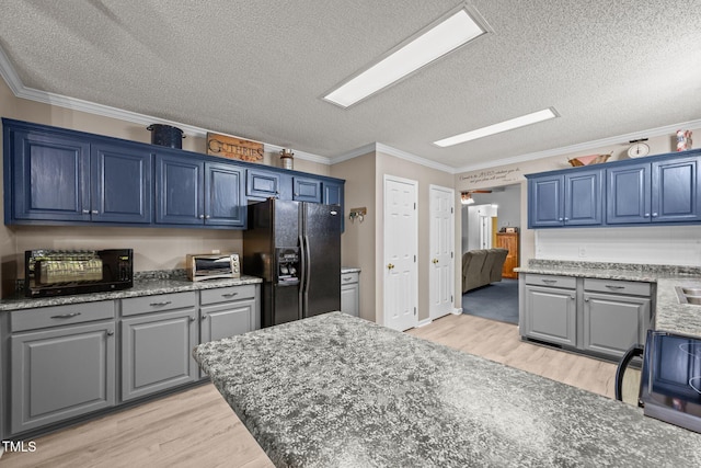 117 Lema Dr, Garner, NC 27529 - kitchen with black appliances, light wood finished floors, a textured ceiling, ornamental molding, and blue cabinets