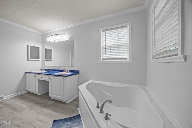 117 Lema Dr, Garner, NC 27529 - bathroom featuring double vanity, wood finished floors, a garden tub, a textured ceiling, and crown molding