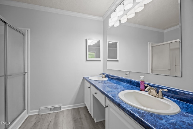 117 Lema Dr, Garner, NC 27529 - full bath with wood finished floors, double vanity, a stall shower, ornamental molding, and baseboards