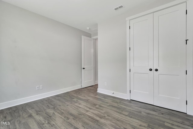 1100 Balsawood Dr Unit 5, Durham, NC 27705 - unfurnished bedroom featuring wood finished floors, baseboards, and a closet