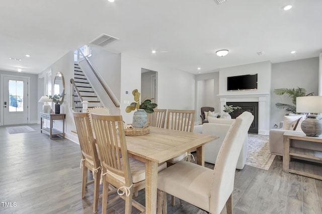 1100 Balsawood Dr Unit 5, Durham, NC 27705 - dining room with wood finished floors, stairs, a fireplace, recessed lighting, and baseboards
