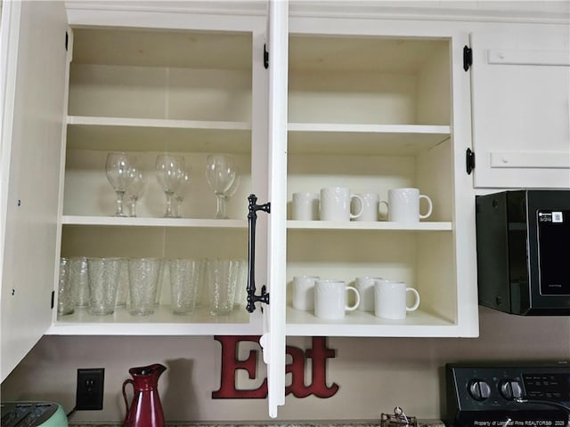 3647 Olivia Rd, Sanford, NC 27332 - kitchen view of open shelves, black microwave, and white cabinets