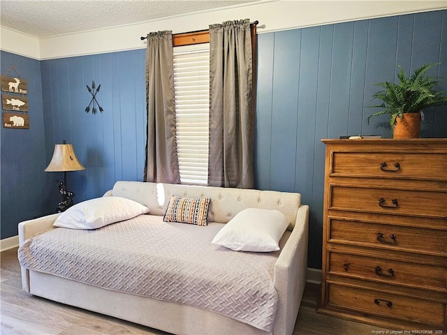 3647 Olivia Rd, Sanford, NC 27332 - bedroom with wood finished floors, wood walls, and a textured ceiling