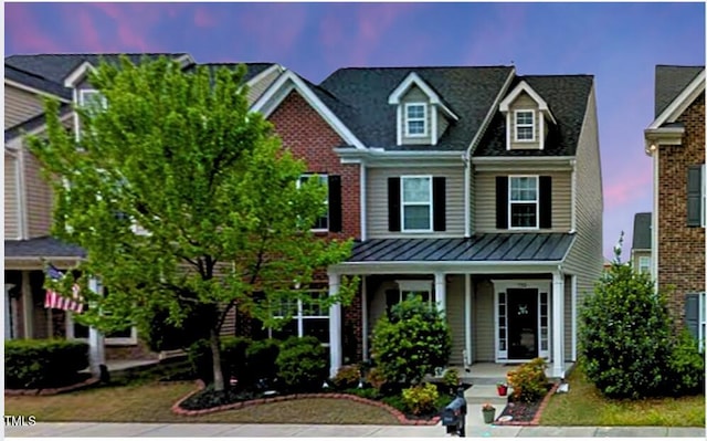 732 Keystone Park Dr, Morrisville, NC 27560 - view of front of house with covered porch and a standing seam roof