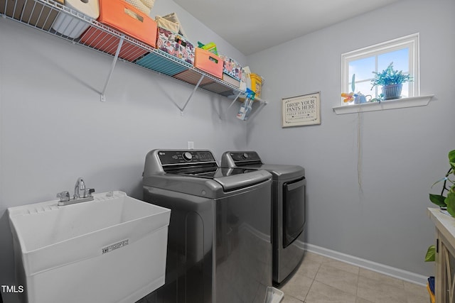 204 Ashland Hill Dr, Holly Springs, NC 27540 - laundry area with washing machine and dryer, baseboards, and light tile patterned floors