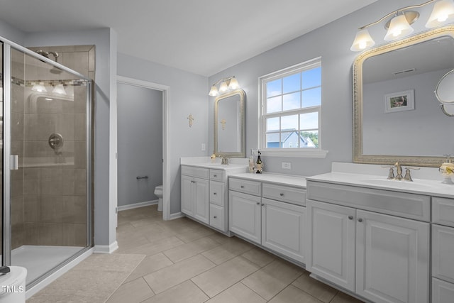 204 Ashland Hill Dr, Holly Springs, NC 27540 - bathroom with double vanity, a shower stall, toilet, and tile patterned flooring