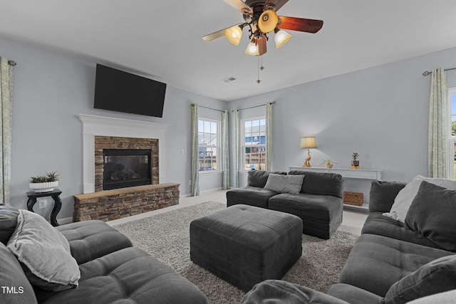 204 Ashland Hill Dr, Holly Springs, NC 27540 - living room with a ceiling fan, carpet flooring, a stone fireplace, and healthy amount of natural light