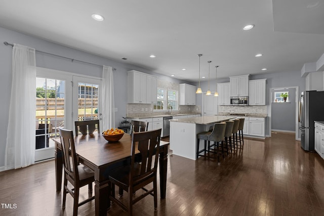 204 Ashland Hill Dr, Holly Springs, NC 27540 - dining room with recessed lighting, dark wood-style flooring, and baseboards