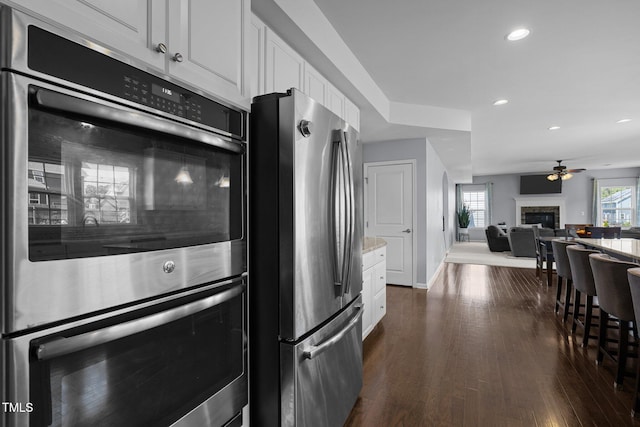 204 Ashland Hill Dr, Holly Springs, NC 27540 - kitchen featuring appliances with stainless steel finishes, a ceiling fan, white cabinetry, baseboards, and recessed lighting