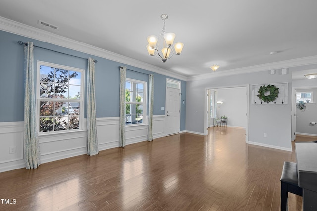 204 Ashland Hill Dr, Holly Springs, NC 27540 - unfurnished living room featuring a chandelier, wainscoting, wood finished floors, and crown molding