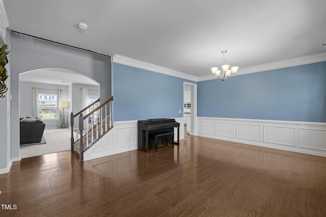 204 Ashland Hill Dr, Holly Springs, NC 27540 - unfurnished room featuring a chandelier, arched walkways, ornamental molding, a smoke detector, and stairs