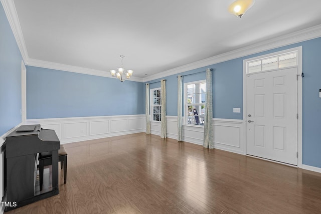 204 Ashland Hill Dr, Holly Springs, NC 27540 - entryway featuring a chandelier, crown molding, wainscoting, and wood finished floors
