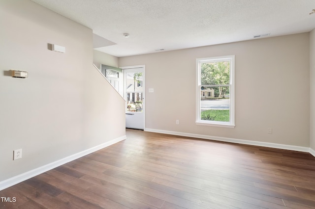 118 Rhum Pl, Garner, NC 27529 - empty room featuring wood finished floors, a textured ceiling, baseboards, and a smoke detector