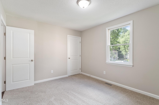 118 Rhum Pl, Garner, NC 27529 - unfurnished bedroom with carpet, a textured ceiling, and baseboards