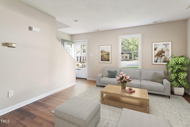 118 Rhum Pl, Garner, NC 27529 - living area featuring wood finished floors, baseboards, and a textured ceiling