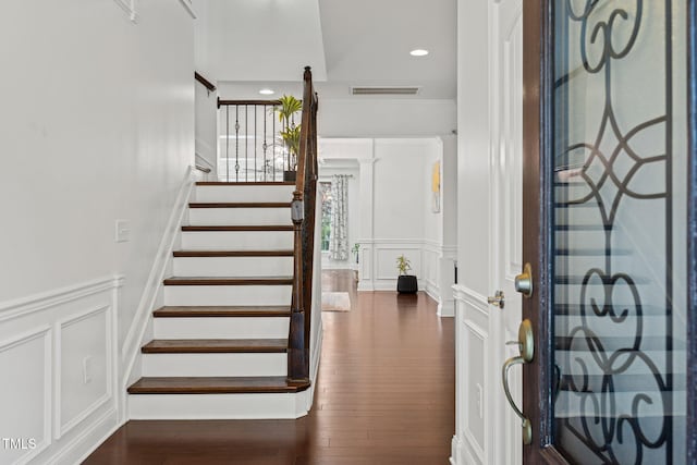 329 Castle Rock Ln, Cary, NC 27519 - foyer featuring a decorative wall, stairs, dark wood-style floors, wainscoting, and recessed lighting