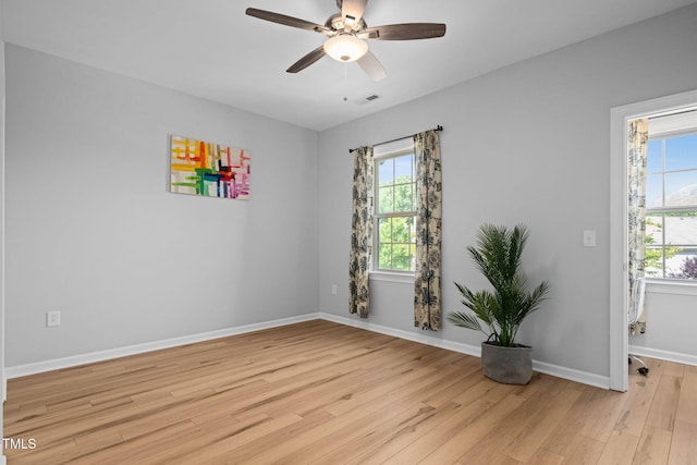 329 Castle Rock Ln, Cary, NC 27519 - spare room featuring light wood-style floors, plenty of natural light, and ceiling fan
