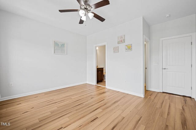 329 Castle Rock Ln, Cary, NC 27519 - unfurnished bedroom featuring light wood-type flooring, connected bathroom, and a ceiling fan