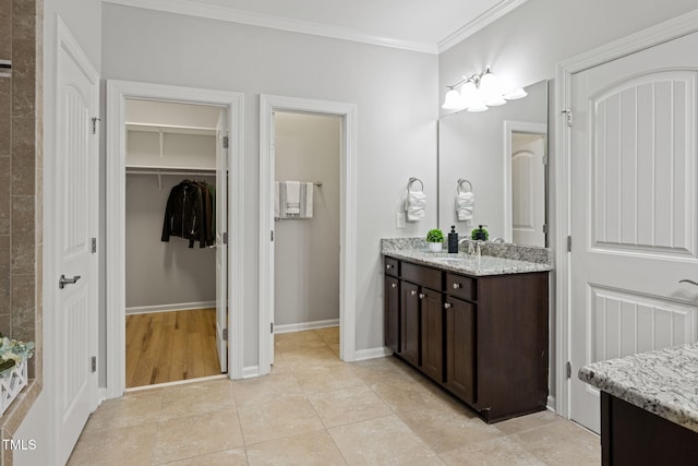 329 Castle Rock Ln, Cary, NC 27519 - bathroom featuring vanity, crown molding, a walk in closet, and tile patterned floors
