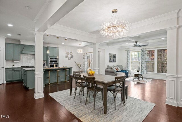 329 Castle Rock Ln, Cary, NC 27519 - dining room featuring decorative columns, ceiling fan, dark wood-type flooring, a chandelier, and crown molding