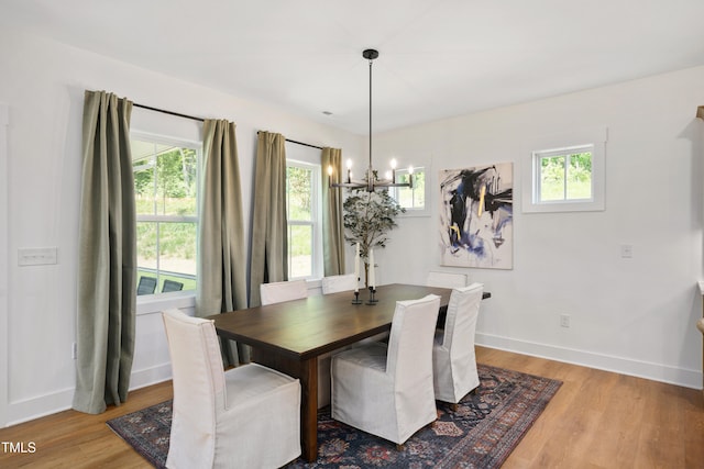 134 Beacon Dr, Pittsboro, NC 27312 - dining space featuring a chandelier, wood finished floors, plenty of natural light, and baseboards