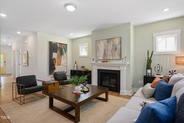 134 Beacon Dr, Pittsboro, NC 27312 - living area featuring light wood-type flooring, a glass covered fireplace, baseboards, and recessed lighting