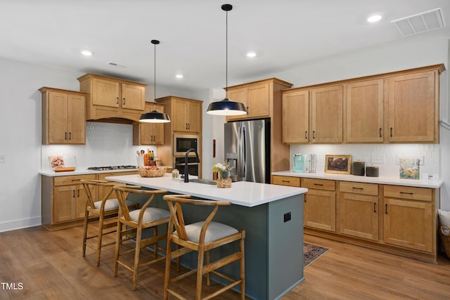 134 Beacon Dr, Pittsboro, NC 27312 - kitchen with stainless steel refrigerator with ice dispenser, built in microwave, a sink, tasteful backsplash, and a kitchen island with sink
