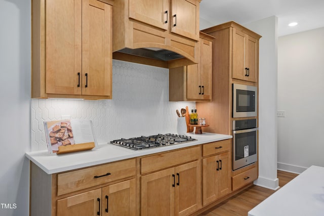 134 Beacon Dr, Pittsboro, NC 27312 - kitchen with stainless steel appliances, light countertops, tasteful backsplash, wood finished floors, and baseboards