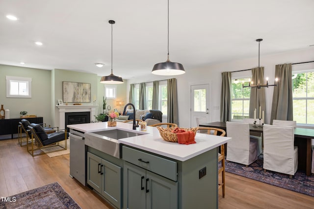 134 Beacon Dr, Pittsboro, NC 27312 - kitchen featuring a sink, open floor plan, stainless steel dishwasher, wood finished floors, and light countertops