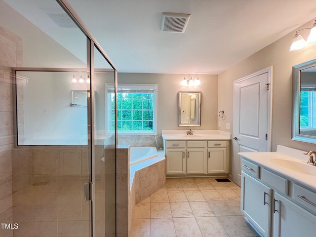 1746 Hammocks Beach Trl, Apex, NC 27502 - bathroom featuring healthy amount of natural light, two vanities, a stall shower, and a garden tub