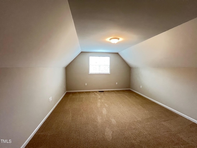 1746 Hammocks Beach Trl, Apex, NC 27502 - additional living space featuring vaulted ceiling, carpet, and baseboards