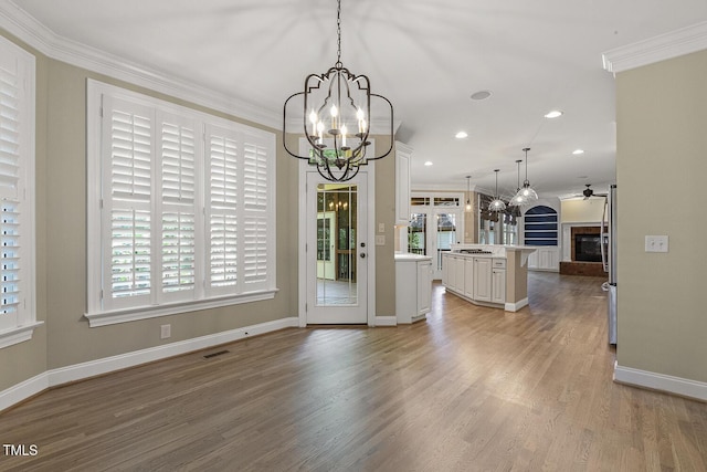 3124 Briar Stream Run, Raleigh, NC 27612 - unfurnished dining area featuring a chandelier, ornamental molding, plenty of natural light, light wood-style flooring, and recessed lighting