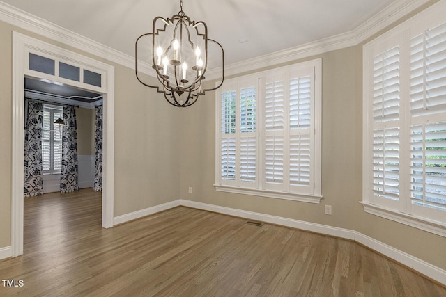 3124 Briar Stream Run, Raleigh, NC 27612 - unfurnished dining area featuring a chandelier, wood finished floors, crown molding, and baseboards