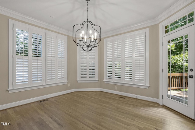 3124 Briar Stream Run, Raleigh, NC 27612 - unfurnished dining area featuring a chandelier, crown molding, baseboards, and wood finished floors