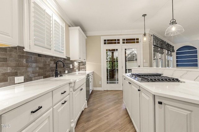 3124 Briar Stream Run, Raleigh, NC 27612 - kitchen with a sink, backsplash, white cabinetry, stainless steel appliances, and ornamental molding