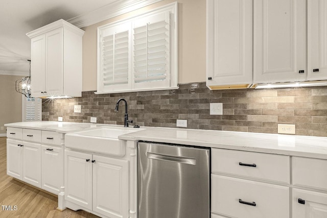 3124 Briar Stream Run, Raleigh, NC 27612 - kitchen featuring stainless steel dishwasher, a sink, ornamental molding, white cabinetry, and light wood-style floors