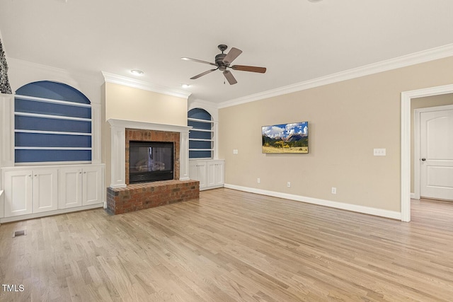 3124 Briar Stream Run, Raleigh, NC 27612 - unfurnished living room with crown molding, ceiling fan, built in shelves, light wood-style flooring, and a brick fireplace