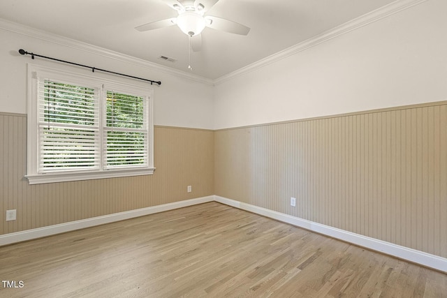 3124 Briar Stream Run, Raleigh, NC 27612 - empty room featuring wood finished floors, ceiling fan, wainscoting, baseboards, and crown molding