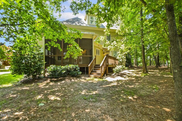 3124 Briar Stream Run, Raleigh, NC 27612 - view of front facade with a sunroom, stairs, and a wooden deck